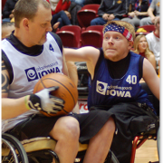 Two basketball players competing for the ball.